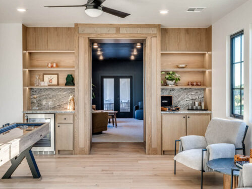 Light oak flooring grounding a relaxed entertainment room with built-in cabinetry