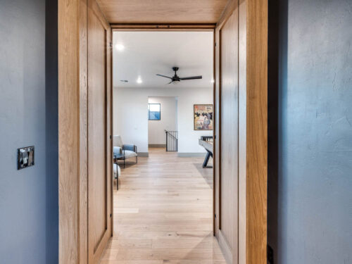 European White Oak flooring paired with rich wood entryway in a home entertainment space
