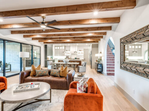 Light European White Oak floors paired with dark ceiling beams and colorful furnishings