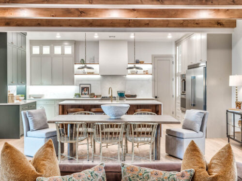Light cool-toned oak floors grounding a neutral kitchen with layered wood details