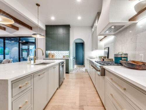 Modern bright kitchen with arched entry into butler's pantry