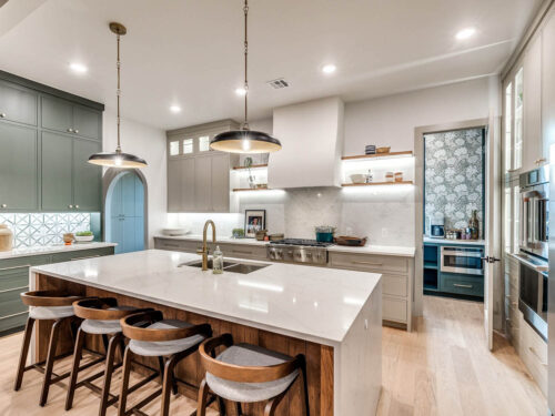 Light European White Oak flooring balancing gray cabinetry in a new build kitchen