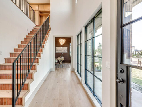 Light European White Oak flooring meeting a custom staircase with decorative tile risers
