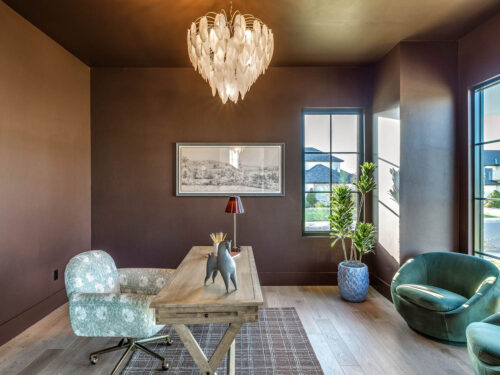 Light oak flooring balancing saturated Rojo Marrón walls and ceiling in a home office