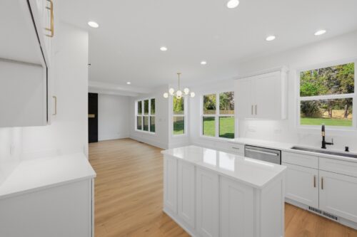 Warm natural flooring creating visual continuity through an open starter home layout