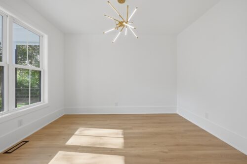 Natural wheat-gold flooring paired with white walls and abundant natural light