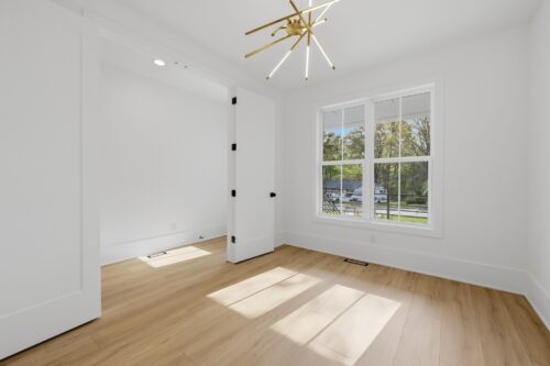 Light wood-look flooring and large windows in a modern Raleigh, NC interior