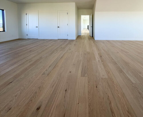 Bedroom interior featuring wide plank European white oak from Real Wood Floors in Bozeman.
