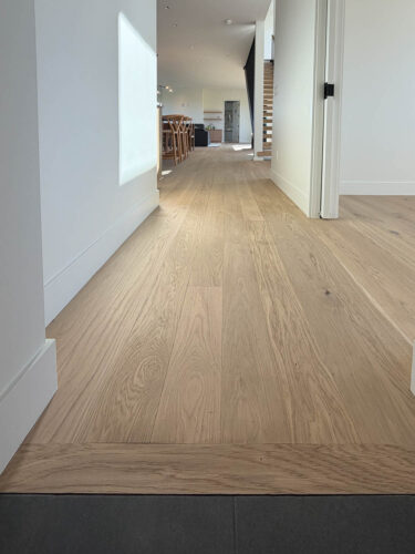 Real Wood Floors European white oak planks along the hallway of a Montana home.