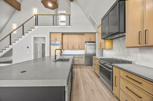Modern rustic kitchen with waterfall island, wood cabinetry, and Retrospect Lily Pond