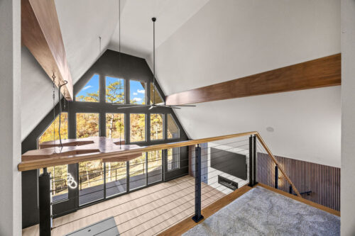 Vaulted ceiling great room with wood flooring grounding modern organic design