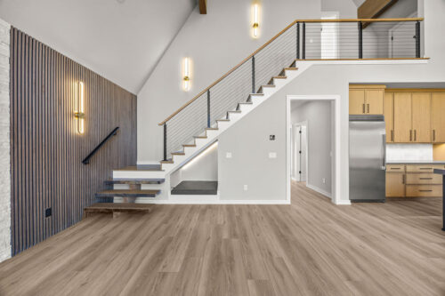 Lakefront great room with open layout and warm modern material palette