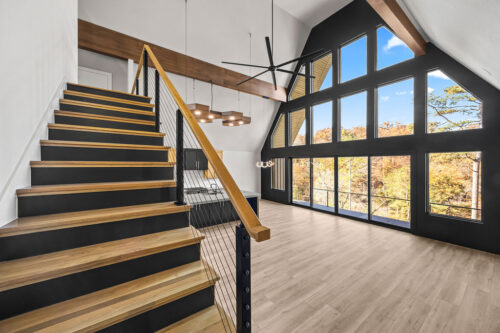Contemporary cabin living room with lake views and natural material palette