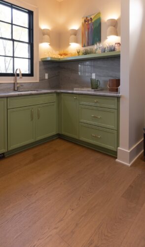 European white oak hardwood flooring connects the kitchen and adjoining butler's pantry, creating a cohesive foundation for layered wood tones.
