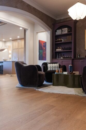 Mont Rochard Provence floors create a natural contrast against dark velvet seating and dramatic plum cabinetry in this Collierville home.