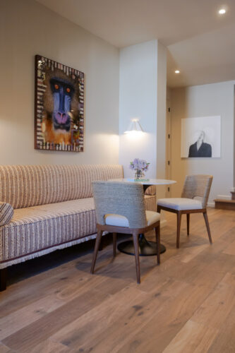 European white oak flooring pairs with upholstered dining chairs, a patterned sofa, and contemporary art in a Memphis-area home.